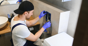 Technician installing bathroom fixtures and fittings – Pro Dallas Bathroom